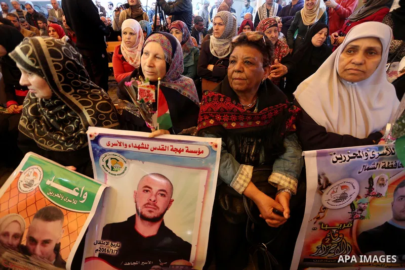 Palestinians hold placards during a protest to show solidarity with Palestinian prisoners held in Israeli Jails, in front of Red cross office in Gaza city, on April 03, 2017. Photo by Mohammed Asad