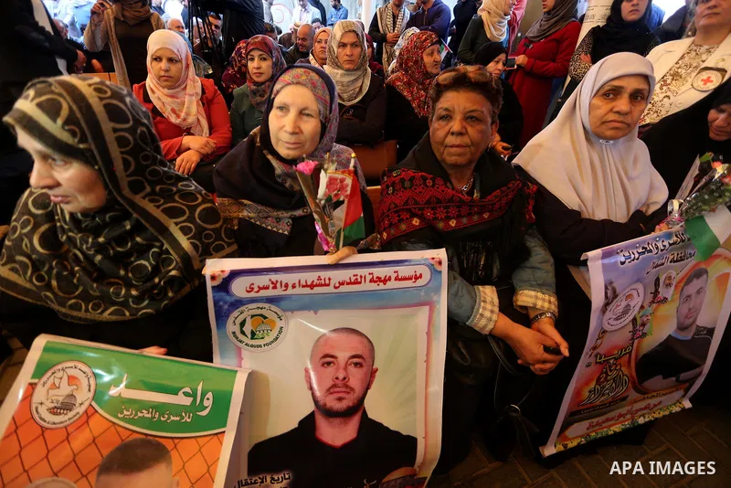 Palestinians hold placards during a protest to show solidarity with Palestinian prisoners held in Israeli Jails, in front of Red cross office in Gaza city, on April 03, 2017. Photo by Mohammed Asad