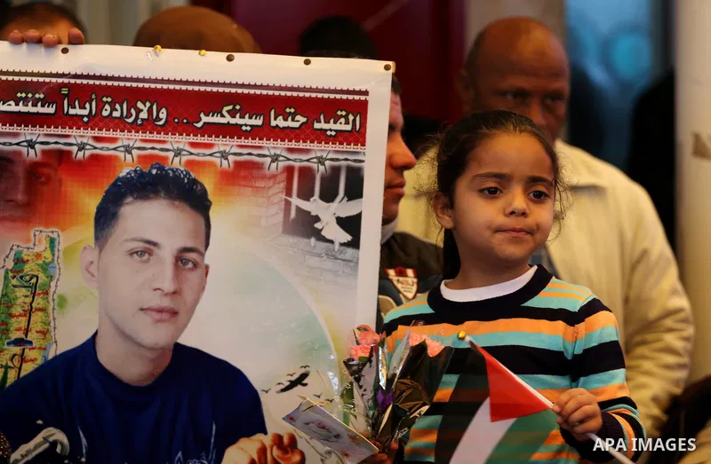 Palestinians hold placards during a protest to show solidarity with Palestinian prisoners held in Israeli Jails, in front of Red cross office in Gaza city, on April 03, 2017. Photo by Mohammed Asad