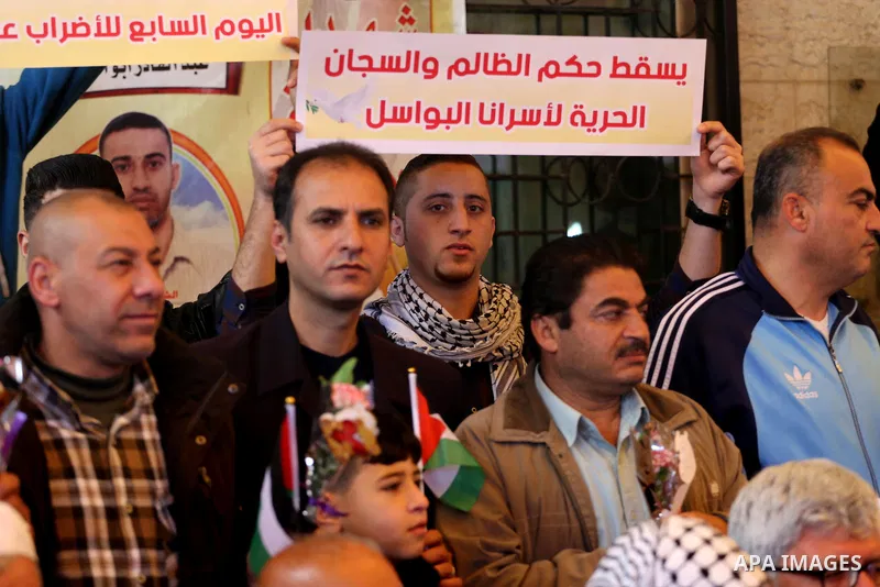 Palestinians hold placards during a protest to show solidarity with Palestinian prisoners held in Israeli Jails, in front of Red cross office in Gaza city, on April 03, 2017. Photo by Mohammed Asad