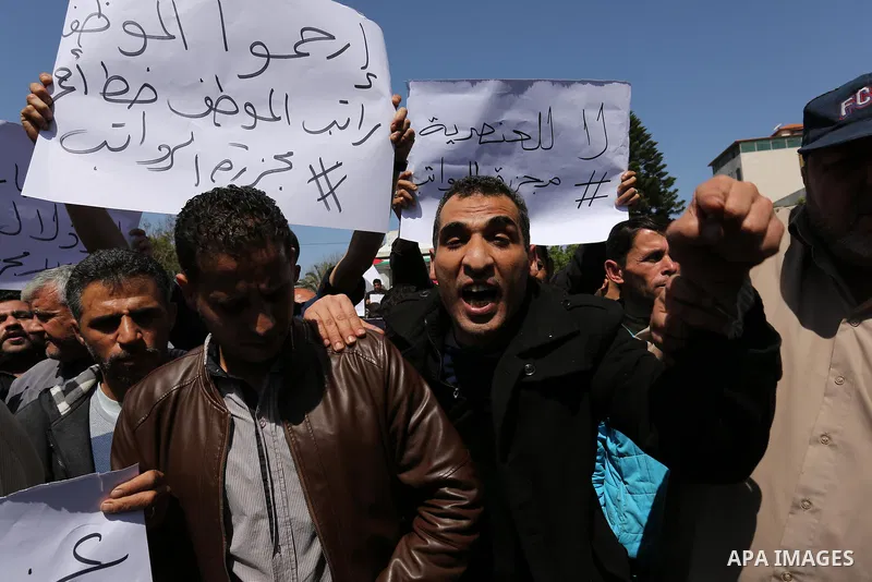 Palestinian employees paid by the Palestinian Authority take part in a protest against the decision of Palestinian goverment to deduct salaries of employees about 30%, in Gaza City April 5, 2017. Photo by Ashraf Amra