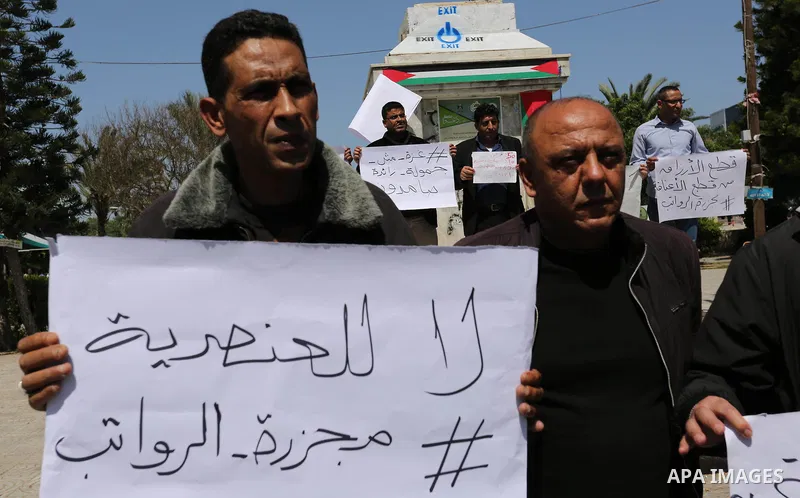 Palestinian employees paid by the Palestinian Authority take part in a protest against the decision of Palestinian goverment to deduct salaries of employees about 30%, in Gaza City April 5, 2017. Photo by Ashraf Amra