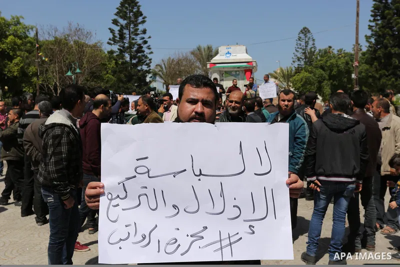 Palestinian employees paid by the Palestinian Authority take part in a protest against the decision of Palestinian goverment to deduct salaries of employees about 30%, in Gaza City April 5, 2017. Photo by Ashraf Amra