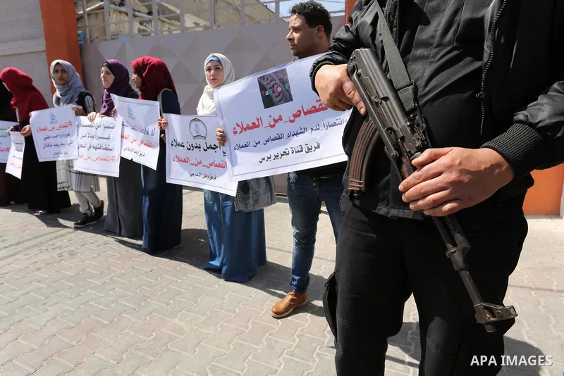 Palestinians hold banners during a protest calling to prosecute collaborators with Israel, in Gaza city on April 05, 2017. Photo by Ashraf Amra