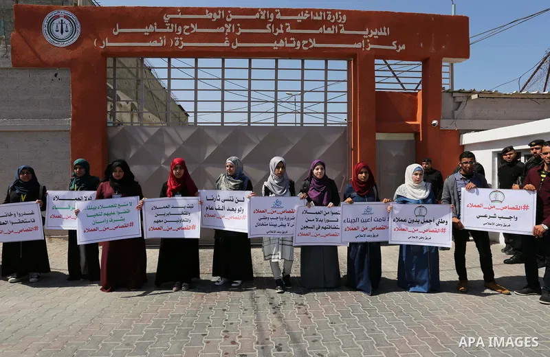 Palestinians hold banners during a protest calling to prosecute collaborators with Israel, in Gaza city on April 05, 2017. Photo by Ashraf Amra