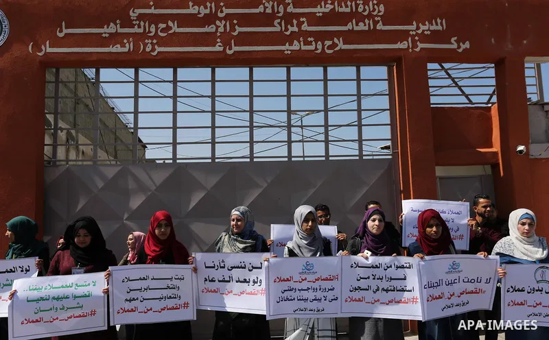 Palestinians hold banners during a protest calling to prosecute collaborators with Israel, in Gaza city on April 05, 2017. Photo by Ashraf Amra