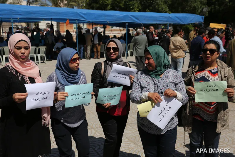 Palestinian employees take part in a protest in Gaza City on April 6, 2017 against a decision by the West Bank-based Palestinian Authority to impose pay cuts on its civil servants in the Gaza Strip. The Palestinian Autho...