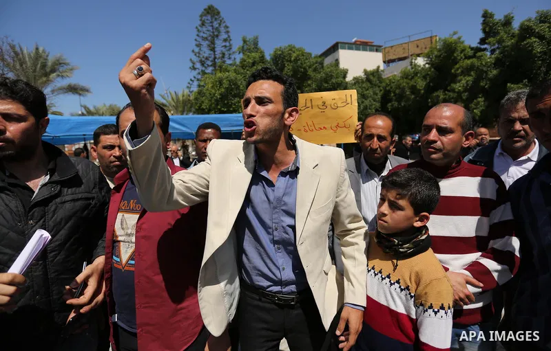 Palestinian employees take part in a protest in Gaza City on April 6, 2017 against a decision by the West Bank-based Palestinian Authority to impose pay cuts on its civil servants in the Gaza Strip. The Palestinian Autho...