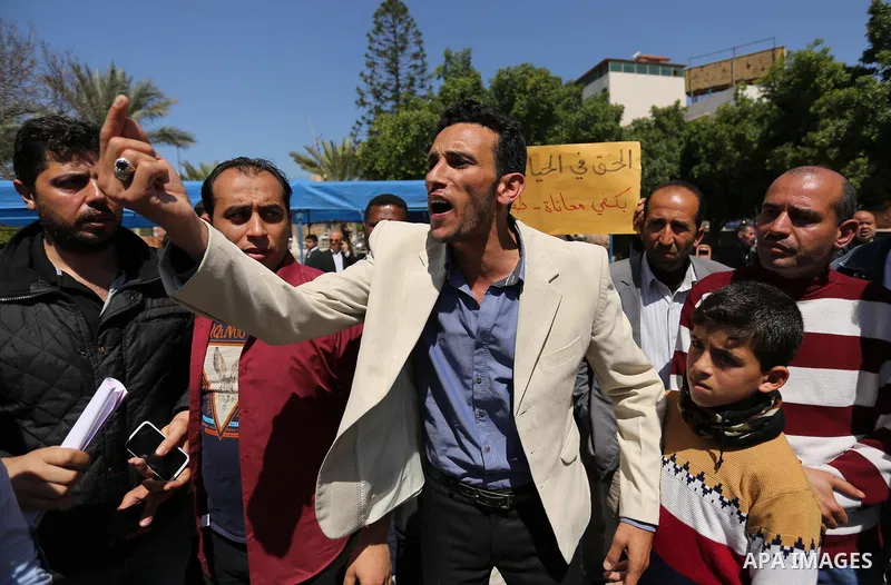 Palestinian employees take part in a protest in Gaza City on April 6, 2017 against a decision by the West Bank-based Palestinian Authority to impose pay cuts on its civil servants in the Gaza Strip. The Palestinian Autho...