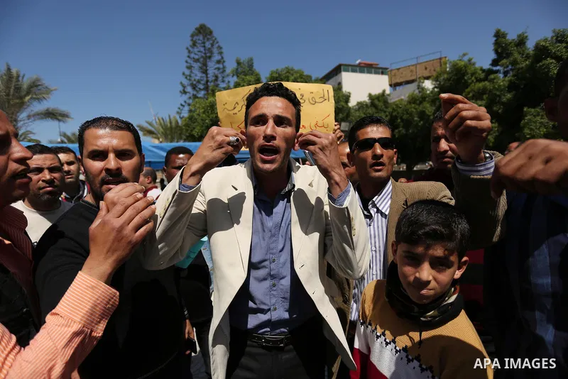 Palestinian employees take part in a protest in Gaza City on April 6, 2017 against a decision by the West Bank-based Palestinian Authority to impose pay cuts on its civil servants in the Gaza Strip. The Palestinian Autho...