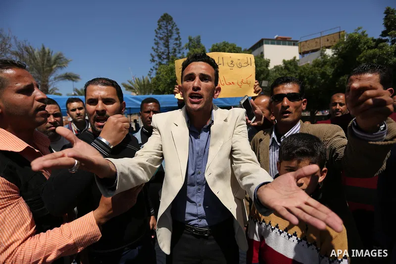 Palestinian employees take part in a protest in Gaza City on April 6, 2017 against a decision by the West Bank-based Palestinian Authority to impose pay cuts on its civil servants in the Gaza Strip. The Palestinian Autho...