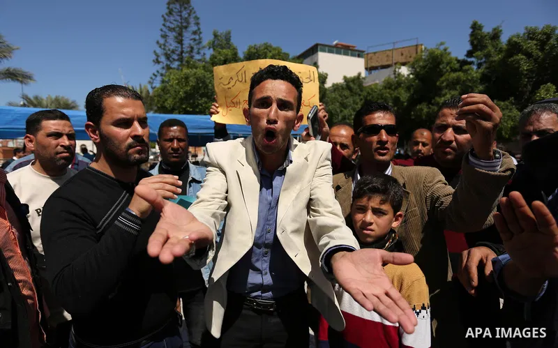 Palestinian employees take part in a protest in Gaza City on April 6, 2017 against a decision by the West Bank-based Palestinian Authority to impose pay cuts on its civil servants in the Gaza Strip. The Palestinian Autho...