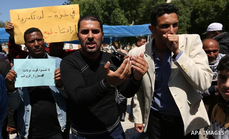Palestinian employees take part in a protest in Gaza City on April 6, 2017 against a decision by the West Bank-based Palestinian Authority to impose pay cuts on its civil servants in the Gaza Strip. The Palestinian Autho...