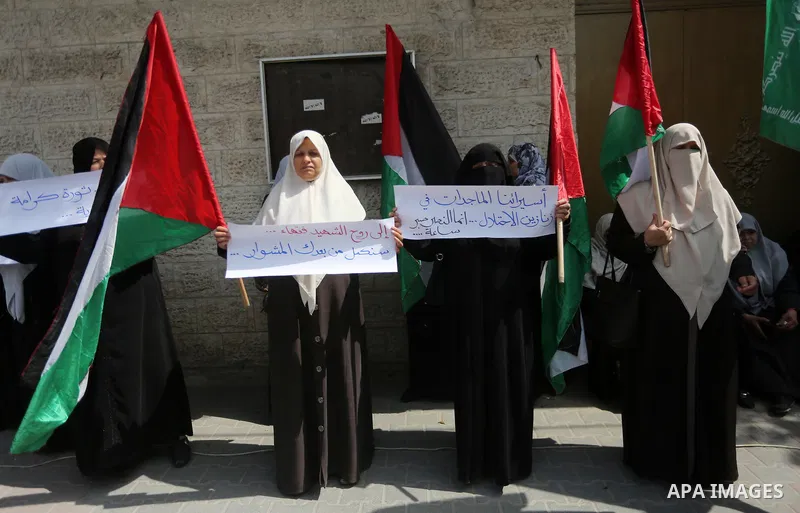 Palestinian women hold banners during a protest to mark Palestinian Prisoner Day, in front of Red cross office in Gaza city, on April 08, 2017. Photo by Mohammed Asad