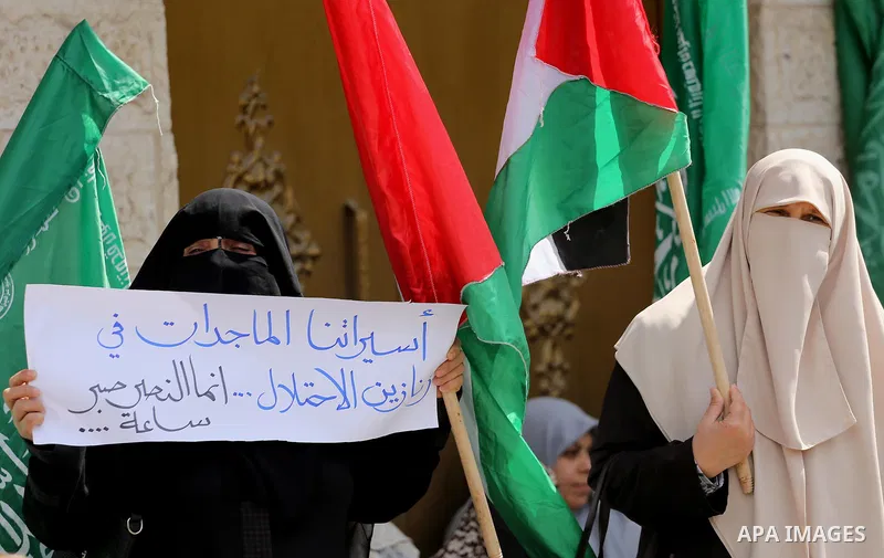 Palestinian women hold banners during a protest to mark Palestinian Prisoner Day, in front of Red cross office in Gaza city, on April 08, 2017. Photo by Mohammed Asad
