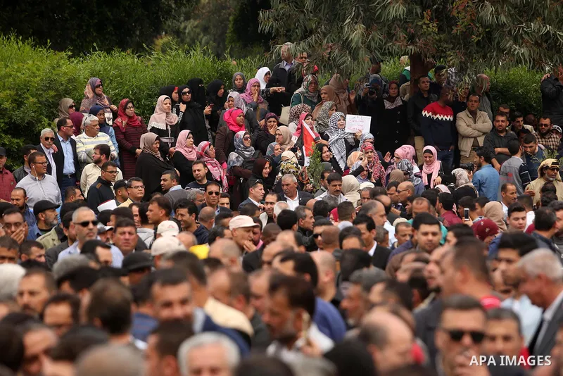 Palestinians, employed by the Palestinian Authority, chant slogans and wave placards during a demonstration against the decision to reduce their salaries in Gaza City on April 8, 2017. Photo by Ashraf Amra