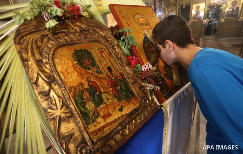 Palestinian Christians take part in the Greek Orthodox Christian Palm Sunday celebrations at St.Porphyrios Church in Gaza City, on April 9, 2017. Palm Sunday marks the triumphant return of Jesus Christ to Jerusalem when...