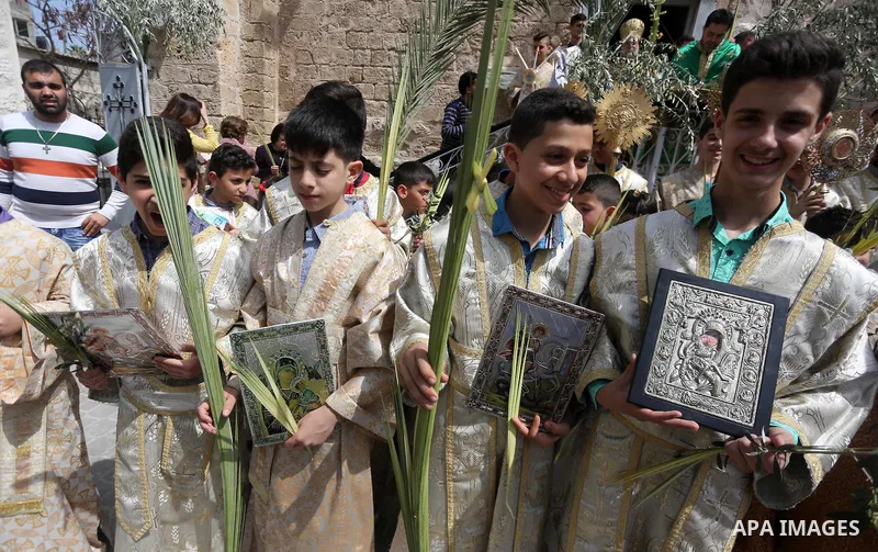 Palestinian Christians take part in the Greek Orthodox Christian Palm Sunday celebrations at St.Porphyrios Church in Gaza City, on April 9, 2017. Palm Sunday marks the triumphant return of Jesus Christ to Jerusalem when...