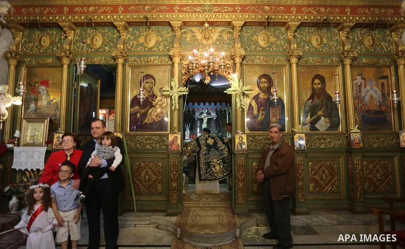 Palestinian Christians take part in the Greek Orthodox Christian Palm Sunday celebrations at St.Porphyrios Church in Gaza City, on April 9, 2017. Palm Sunday marks the triumphant return of Jesus Christ to Jerusalem when...