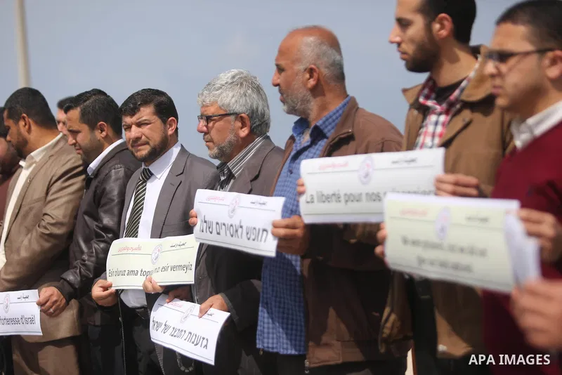 Palestinians hold placards during a protest to show solidarity with Palestinian prisoners held in Israeli Jails, in Gaza city, on April 9, 2017. Photo by Ashraf Amra