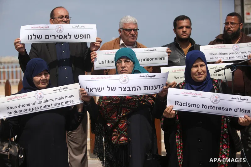 Palestinians hold placards during a protest to show solidarity with Palestinian prisoners held in Israeli Jails, in Gaza city, on April 9, 2017. Photo by Ashraf Amra