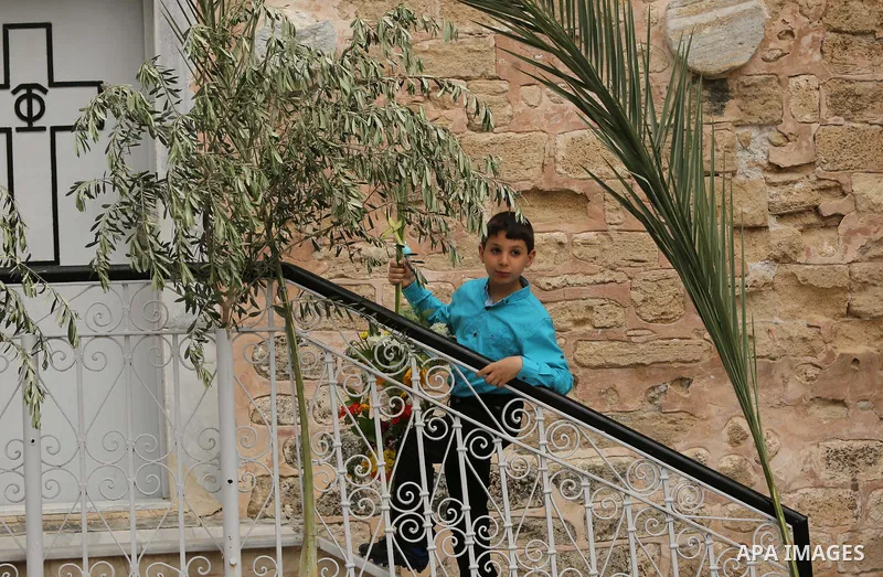 Palestinian Christians take part in the Greek Orthodox Christian Palm Sunday celebrations at St.Porphyrios Church in Gaza City, on April 9, 2017. Palm Sunday marks the triumphant return of Jesus Christ to Jerusalem when...