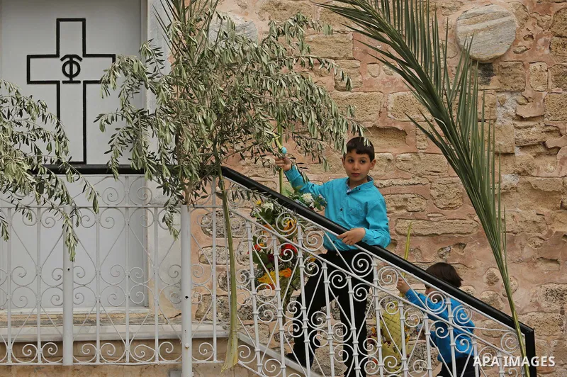 Palestinian Christians take part in the Greek Orthodox Christian Palm Sunday celebrations at St.Porphyrios Church in Gaza City, on April 9, 2017. Palm Sunday marks the triumphant return of Jesus Christ to Jerusalem when...