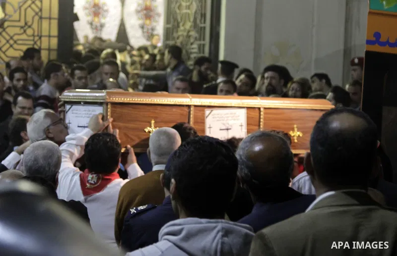Relatives of victims react to coffins arriving to the Mar Girgis Coptic Orthodox Church in the Nile Delta City of Tanta, 120 kilometres (75 miles) north of Cairo, at which a bomb blast struck worshippers gathering to att...