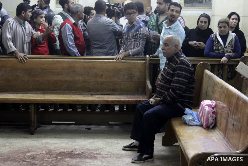 Relatives of a victim react inside the Mar Girgis Coptic Orthodox Church that was bombed on Sunday in the Nile Delta City of Tanta, 120 kilometres (75 miles) north of Cairo, at which a bomb blast struck worshippers gathe...