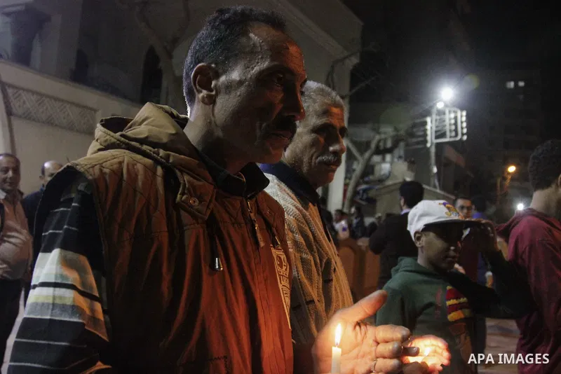 Relatives of a victim react inside the Mar Girgis Coptic Orthodox Church that was bombed on Sunday in the Nile Delta City of Tanta, 120 kilometres (75 miles) north of Cairo, at which a bomb blast struck worshippers gathe...