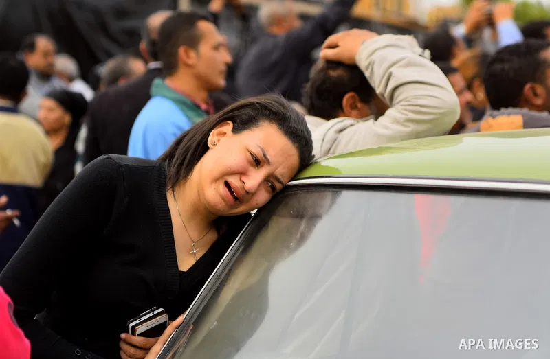 An Egyptian Christian woman mourns for the victims of the blast at the Coptic Christian Saint Mark's church in Alexandria the previous day during a funeral procession at the Monastery of Marmina in the city of Borg El-Ar...