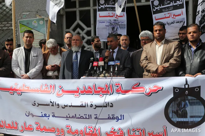Palestinians hold placards during a protest to show solidarity with Palestinian prisoners held in Israeli Jails, in Gaza city, on April 11, 2017. Photo by Mohammed Asad