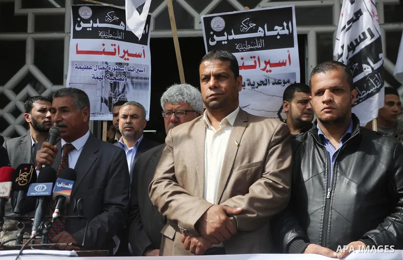 Palestinians hold placards during a protest to show solidarity with Palestinian prisoners held in Israeli Jails, in Gaza city, on April 11, 2017. Photo by Mohammed Asad