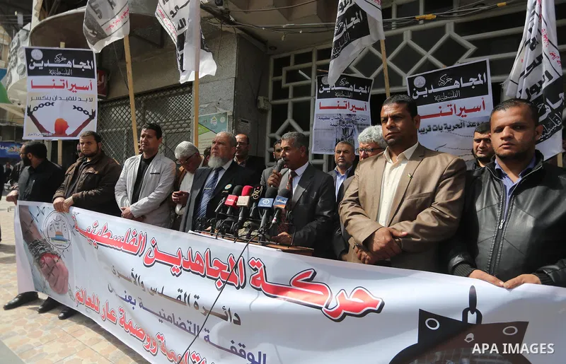 Palestinians hold placards during a protest to show solidarity with Palestinian prisoners held in Israeli Jails, in Gaza city, on April 11, 2017. Photo by Mohammed Asad