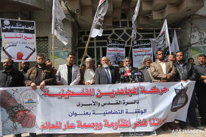 Palestinians hold placards during a protest to show solidarity with Palestinian prisoners held in Israeli Jails, in Gaza city, on April 11, 2017. Photo by Mohammed Asad