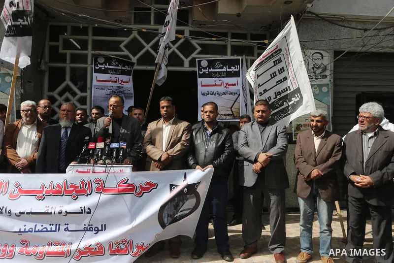 Palestinians hold placards during a protest to show solidarity with Palestinian prisoners held in Israeli Jails, in Gaza city, on April 11, 2017. Photo by Mohammed Asad