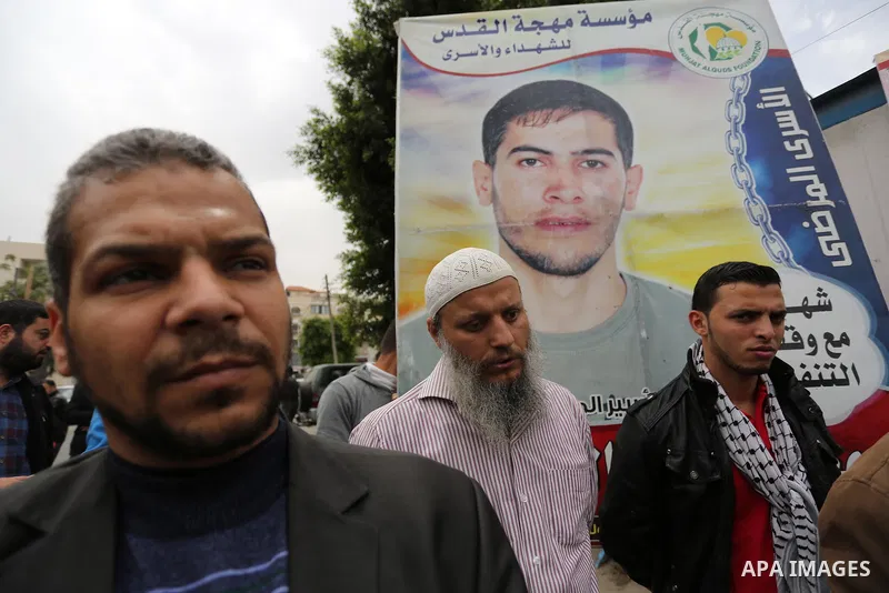 Palestinians hold placards during a protest to show solidarity with Palestinian prisoners held in Israeli Jails, in Gaza city, on April 12, 2017. Photo by Ashraf Amra