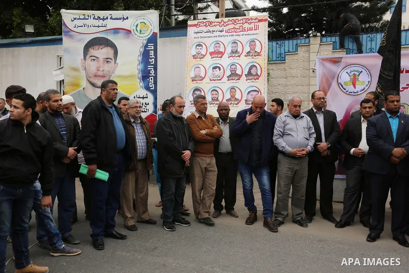 Palestinians hold placards during a protest to show solidarity with Palestinian prisoners held in Israeli Jails, in Gaza city, on April 12, 2017. Photo by Ashraf Amra