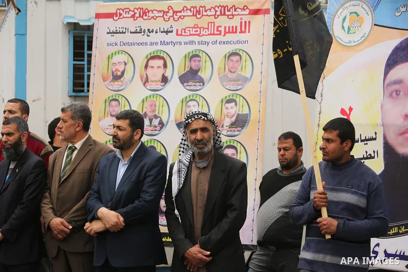 Palestinians hold placards during a protest to show solidarity with Palestinian prisoners held in Israeli Jails, in Gaza city, on April 12, 2017. Photo by Ashraf Amra