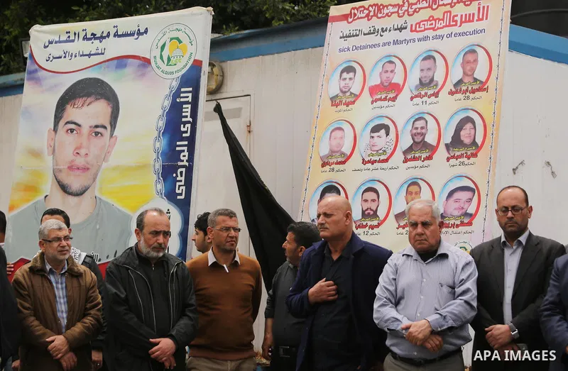 Palestinians hold placards during a protest to show solidarity with Palestinian prisoners held in Israeli Jails, in Gaza city, on April 12, 2017. Photo by Ashraf Amra