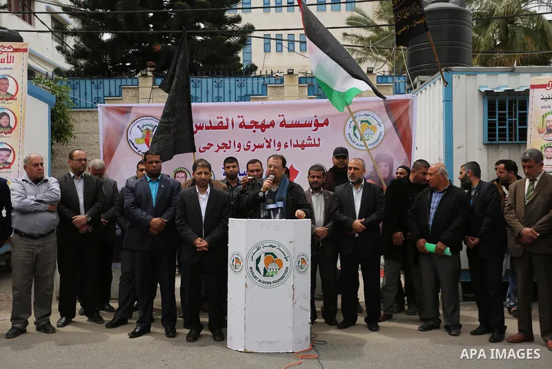 Palestinians hold placards during a protest to show solidarity with Palestinian prisoners held in Israeli Jails, in Gaza city, on April 12, 2017. Photo by Ashraf Amra