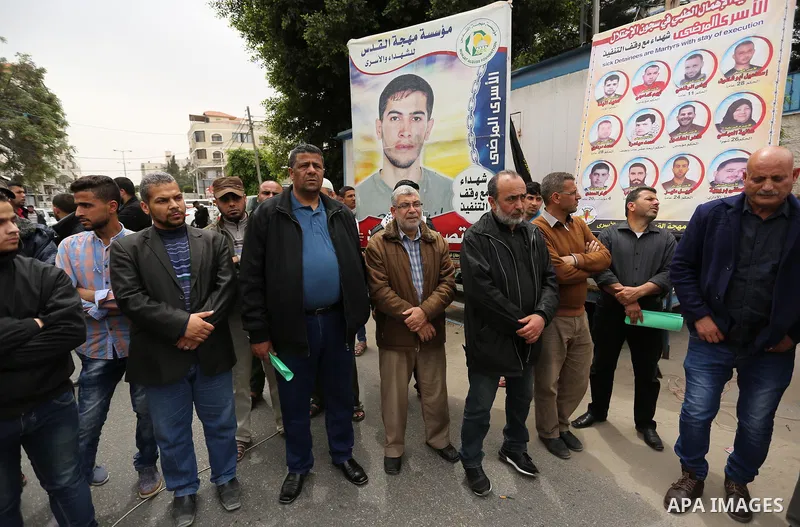 Palestinians hold placards during a protest to show solidarity with Palestinian prisoners held in Israeli Jails, in Gaza city, on April 12, 2017. Photo by Ashraf Amra