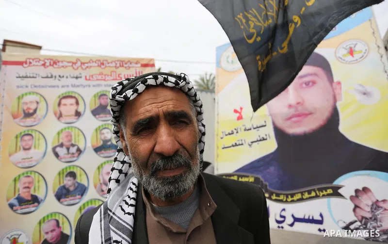 Palestinians hold placards during a protest to show solidarity with Palestinian prisoners held in Israeli Jails, in Gaza city, on April 12, 2017. Photo by Ashraf Amra
