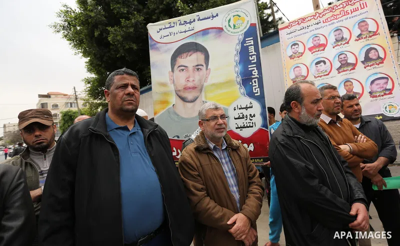 Palestinians hold placards during a protest to show solidarity with Palestinian prisoners held in Israeli Jails, in Gaza city, on April 12, 2017. Photo by Ashraf Amra