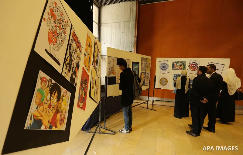 Palestinians attend the anime gallery for the disabled Mohammed Dalu, in Gaza city, on April 12, 2017. Photo by Ashraf Amra