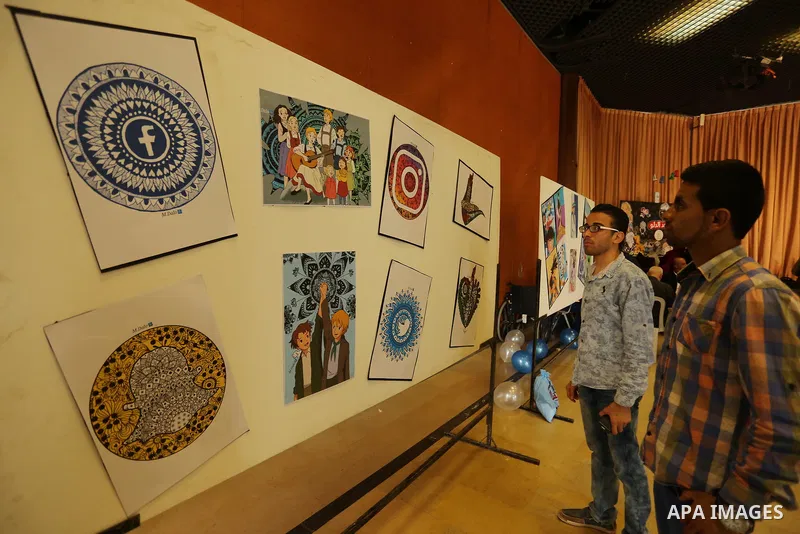 Palestinians attend the anime gallery for the disabled Mohammed Dalu, in Gaza city, on April 12, 2017. Photo by Ashraf Amra