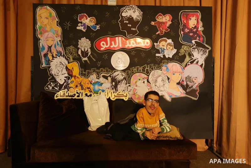 A Palestinian disabled Mohammed Dalu, opens his the anime gallery, in Gaza city, on April 12, 2017. Photo by Ashraf Amra