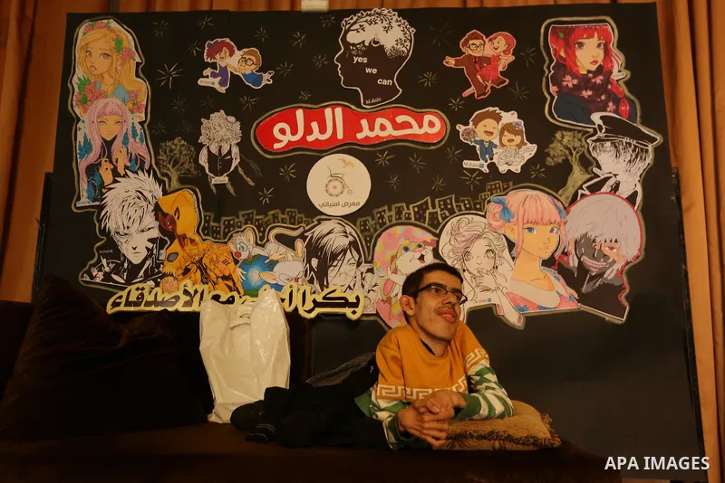 A Palestinian disabled Mohammed Dalu, opens his the anime gallery, in Gaza city, on April 12, 2017. Photo by Ashraf Amra