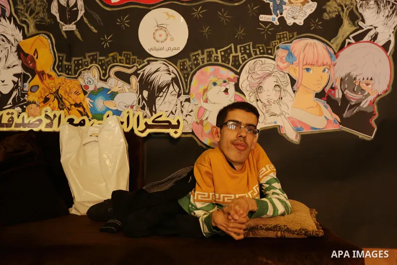 A Palestinian disabled Mohammed Dalu, opens his the anime gallery, in Gaza city, on April 12, 2017. Photo by Ashraf Amra