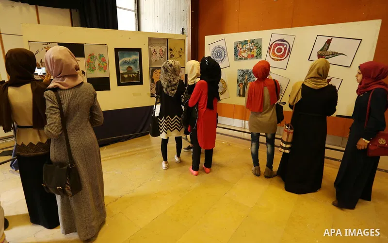 Palestinians attend the anime gallery for the disabled Mohammed Dalu, in Gaza city, on April 12, 2017. Photo by Ashraf Amra